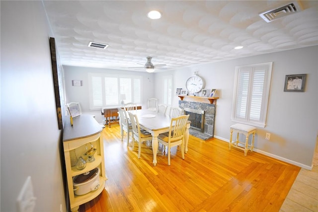 14 Willow Dr, Cranston, RI 02920 - dining space with a ceiling fan, a stone fireplace, recessed lighting, and light wood-type flooring