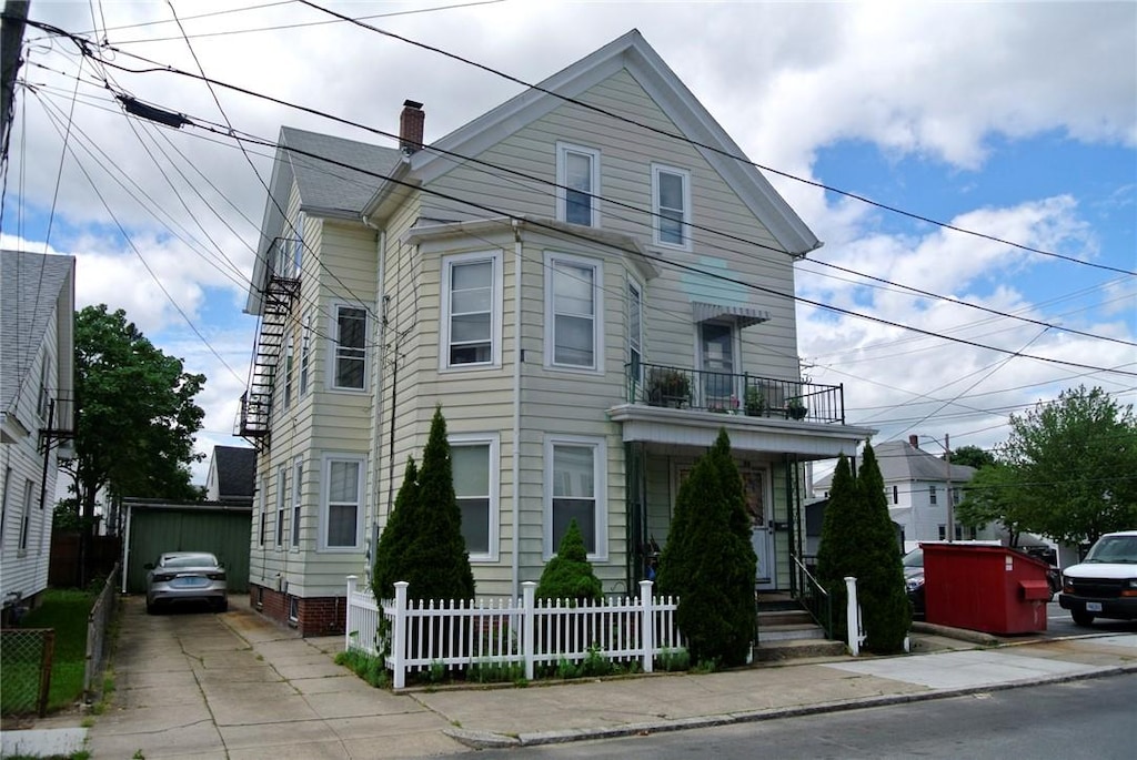 18 Standish Ave, Cranston, RI 02920 - view of front facade with a balcony and a chimney