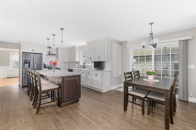32 Susan Dr, Cumberland, RI 02864 - kitchen featuring appliances with stainless steel finishes, a chandelier, wood finished floors, and white cabinetry