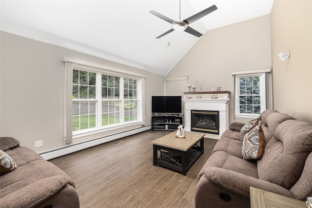 32 Susan Dr, Cumberland, RI 02864 - living room featuring high vaulted ceiling, healthy amount of natural light, wood finished floors, a glass covered fireplace, and a ceiling fan