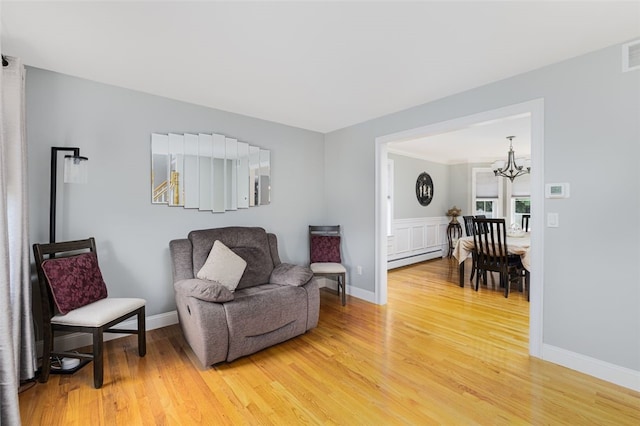 32 Susan Dr, Cumberland, RI 02864 - sitting room featuring light wood-type flooring, baseboard heating, and a chandelier