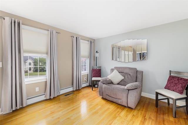 32 Susan Dr, Cumberland, RI 02864 - sitting room featuring healthy amount of natural light, wood finished floors, and a baseboard radiator
