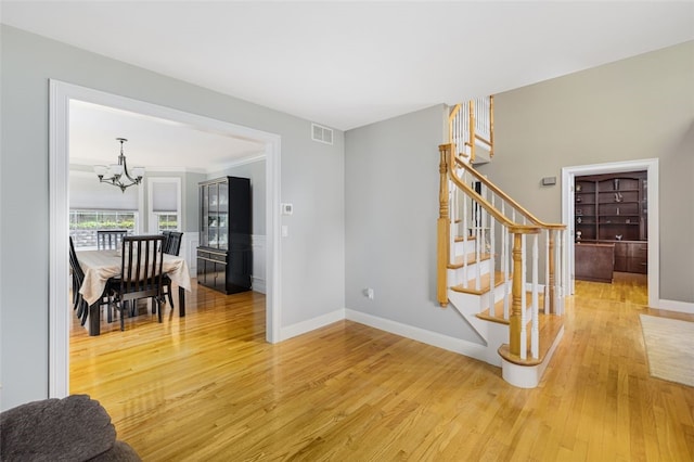 32 Susan Dr, Cumberland, RI 02864 - entrance foyer with stairs, a chandelier, and light wood finished floors