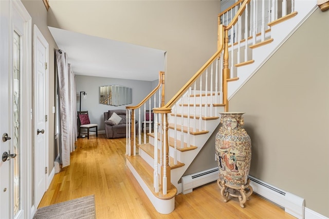 32 Susan Dr, Cumberland, RI 02864 - entrance foyer featuring a baseboard heating unit, wood finished floors, and stairs