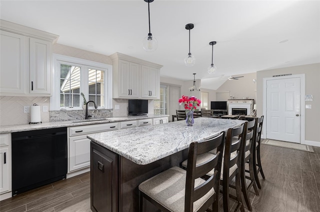 32 Susan Dr, Cumberland, RI 02864 - kitchen featuring black dishwasher, dark wood-style flooring, plenty of natural light, and white cabinets
