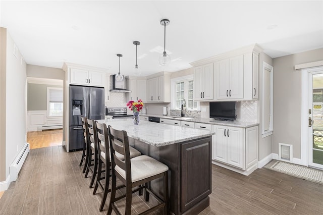 32 Susan Dr, Cumberland, RI 02864 - kitchen featuring a baseboard radiator, appliances with stainless steel finishes, decorative backsplash, and dark wood-type flooring