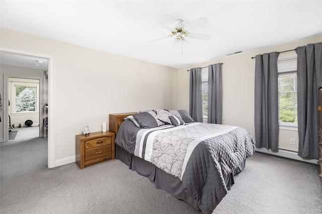 32 Susan Dr, Cumberland, RI 02864 - carpeted bedroom with multiple windows, a ceiling fan, and a baseboard heating unit