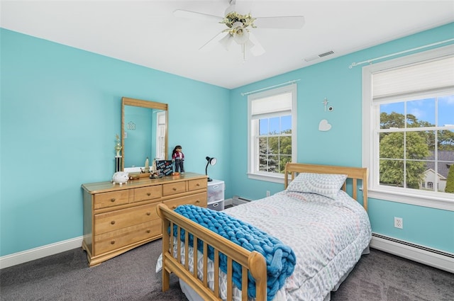 32 Susan Dr, Cumberland, RI 02864 - bedroom featuring a baseboard heating unit, dark carpet, multiple windows, and ceiling fan