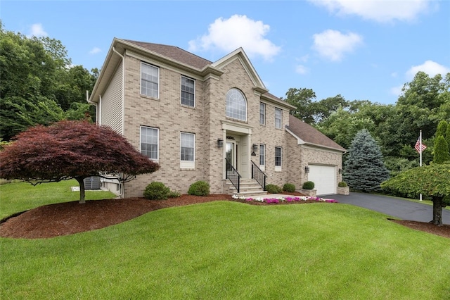32 Susan Dr, Cumberland, RI 02864 - view of front of home with a front yard, asphalt driveway, brick siding, an attached garage, and entry steps