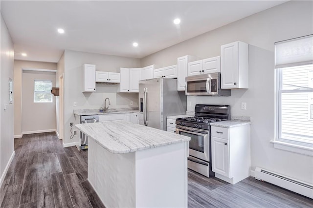 15 Wendell St, Providence, RI 02909 - kitchen featuring stainless steel appliances, a baseboard radiator, a center island, white cabinetry, and dark wood-type flooring