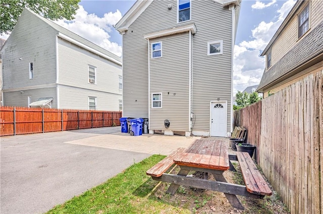 15 Wendell St, Providence, RI 02909 - rear view of house featuring a fenced backyard and a patio area