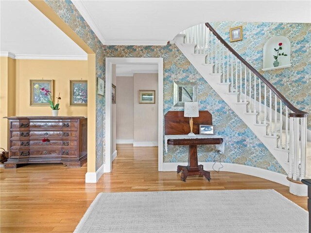 173 Gaskill St, Woonsocket, RI 02895 - stairs with wallpapered walls, wood finished floors, and ornamental molding