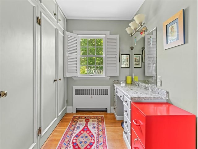 173 Gaskill St, Woonsocket, RI 02895 - bathroom featuring radiator heating unit, vanity, wood finished floors, and crown molding