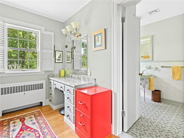 173 Gaskill St, Woonsocket, RI 02895 - bathroom featuring radiator heating unit, crown molding, and vanity