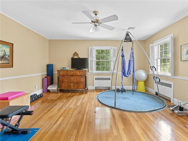 173 Gaskill St, Woonsocket, RI 02895 - exercise area featuring radiator, wood finished floors, and healthy amount of natural light