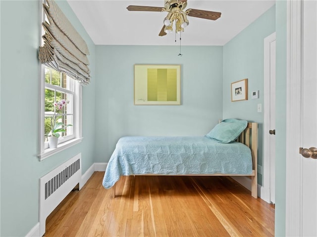 173 Gaskill St, Woonsocket, RI 02895 - bedroom with radiator heating unit, wood finished floors, and ceiling fan