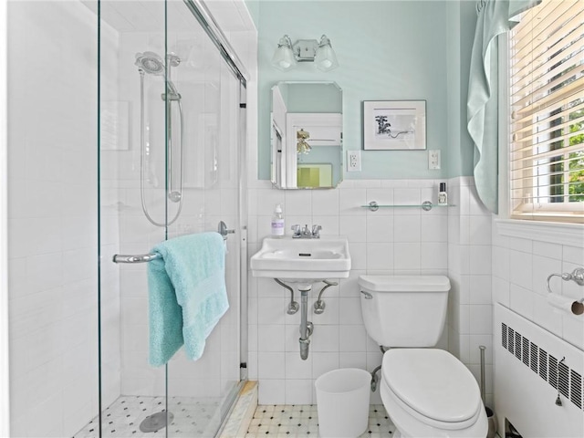 173 Gaskill St, Woonsocket, RI 02895 - full bathroom with radiator heating unit, a stall shower, tile walls, and a wainscoted wall