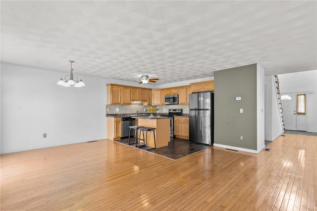 1 Lisi Ln Unit 1, Providence, RI 02904 - kitchen with stainless steel appliances, a chandelier, a breakfast bar, a kitchen island, and dark countertops