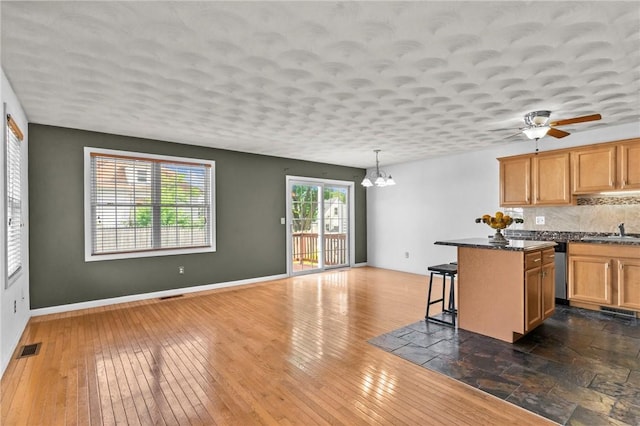 1 Lisi Ln Unit 1, Providence, RI 02904 - kitchen featuring a breakfast bar, a chandelier, backsplash, a center island, and open floor plan