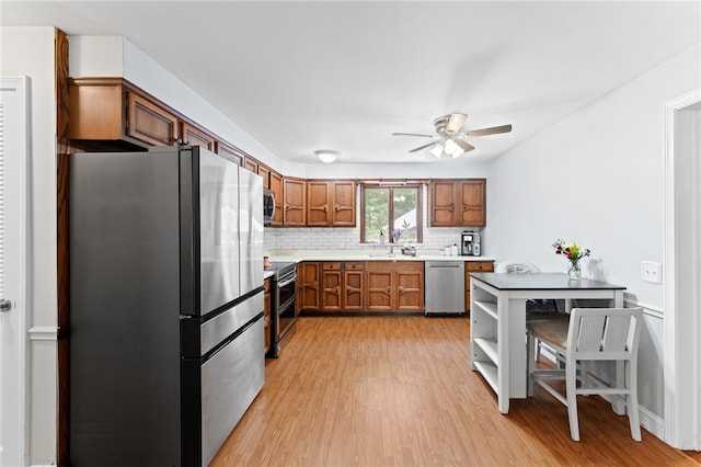 85 N Cobble Hill Rd, Warwick, RI 02886 - kitchen featuring appliances with stainless steel finishes, a ceiling fan, light wood-style floors, light countertops, and brown cabinets