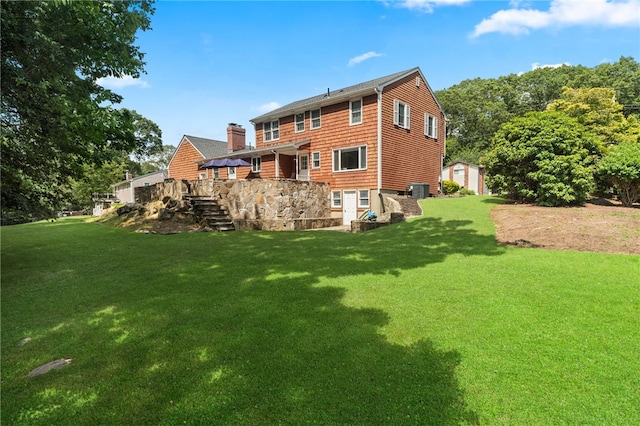 85 N Cobble Hill Rd, Warwick, RI 02886 - rear view of property featuring a chimney, a lawn, a storage shed, and a wooden deck