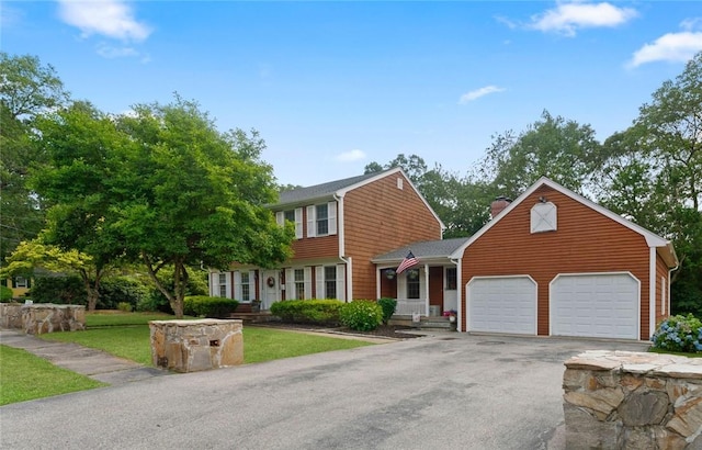 85 N Cobble Hill Rd, Warwick, RI 02886 - view of front of home with a chimney, asphalt driveway, an attached garage, and a front lawn