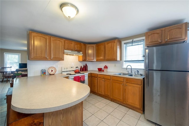 61 Penn St, Providence, RI 02909 - kitchen featuring freestanding refrigerator, white electric range oven, under cabinet range hood, a peninsula, and light countertops
