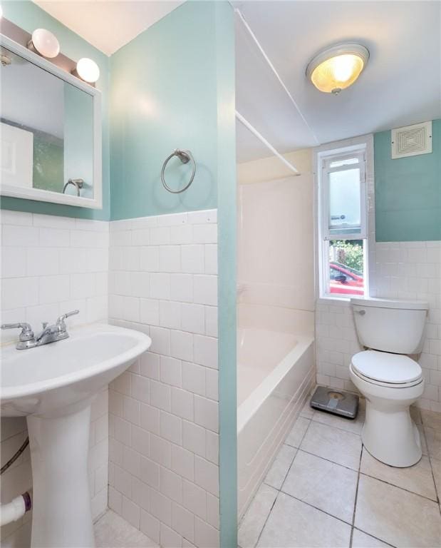 61 Penn St, Providence, RI 02909 - full bath with tile walls, tile patterned flooring, shower / bathtub combination, and wainscoting