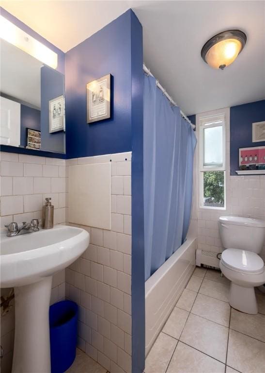 61 Penn St, Providence, RI 02909 - full bathroom with tile walls, tile patterned flooring, shower / bath combo with shower curtain, and a wainscoted wall