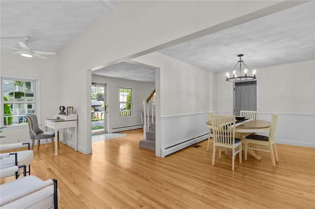 188 Reynolds Ave, Warwick, RI 02889 - dining space with baseboard heating, light wood-style floors, a chandelier, and stairs
