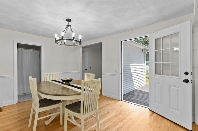 188 Reynolds Ave, Warwick, RI 02889 - dining room with a chandelier, light wood-style floors, and wainscoting