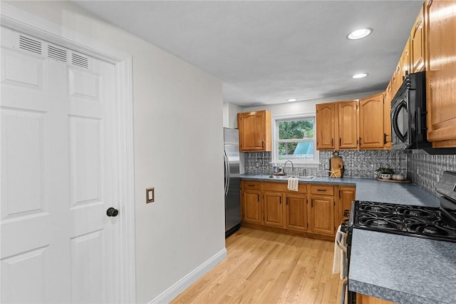 188 Reynolds Ave, Warwick, RI 02889 - kitchen featuring stainless steel appliances, light wood-type flooring, decorative backsplash, brown cabinetry, and recessed lighting