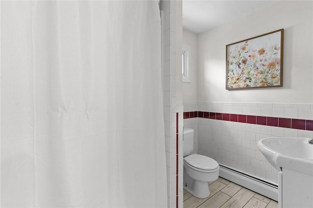 188 Reynolds Ave, Warwick, RI 02889 - full bath featuring baseboard heating, tile walls, and wainscoting