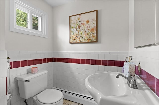 188 Reynolds Ave, Warwick, RI 02889 - bathroom featuring tile walls, a baseboard heating unit, and a wainscoted wall