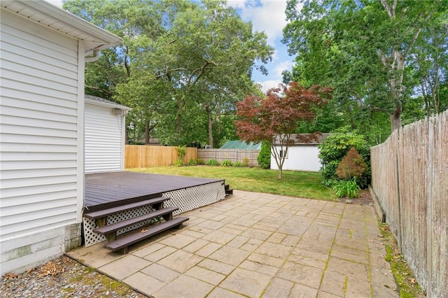 188 Reynolds Ave, Warwick, RI 02889 - fenced backyard with a deck, a patio area, and a storage unit