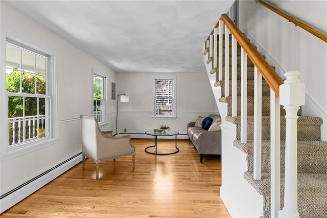 188 Reynolds Ave, Warwick, RI 02889 - living area featuring a baseboard heating unit, stairs, and light wood finished floors