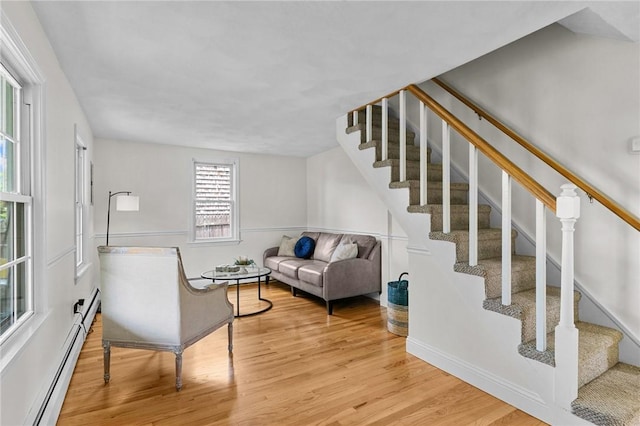 188 Reynolds Ave, Warwick, RI 02889 - living room featuring a baseboard heating unit, wood finished floors, and stairs