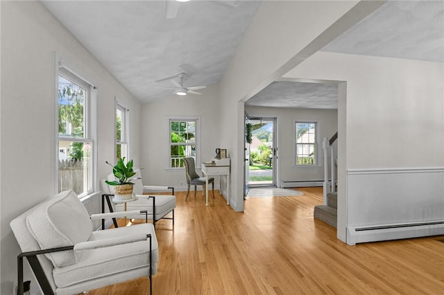 188 Reynolds Ave, Warwick, RI 02889 - living area with baseboard heating, ceiling fan, light wood-style flooring, stairs, and lofted ceiling