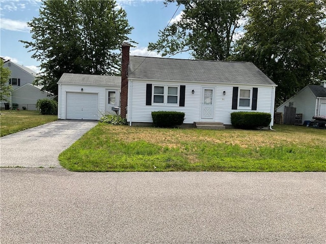 94 Alvin St, Warwick, RI 02886 - view of front of home featuring entry steps, a garage, a chimney, and a front lawn