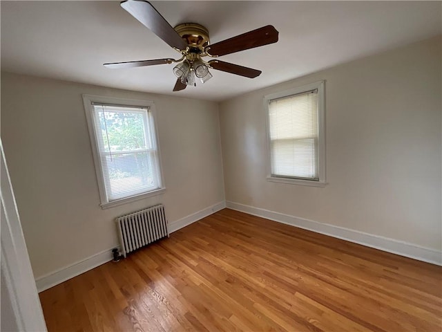 94 Alvin St, Warwick, RI 02886 - spare room with radiator, light wood-type flooring, and ceiling fan