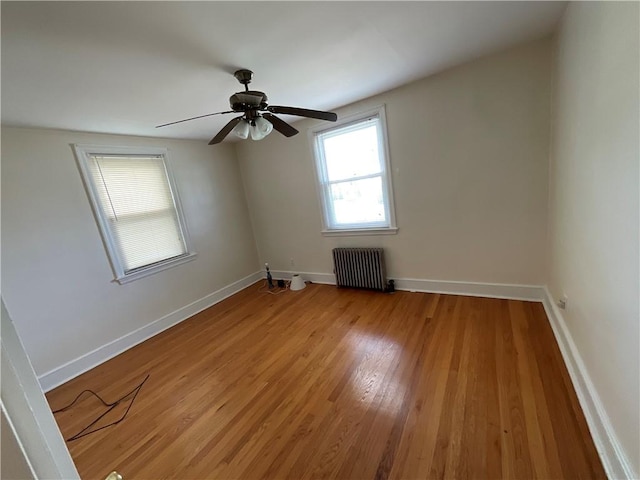 94 Alvin St, Warwick, RI 02886 - empty room with radiator heating unit, light wood finished floors, and ceiling fan