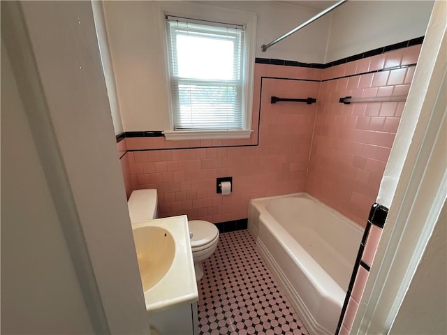 94 Alvin St, Warwick, RI 02886 - bathroom featuring tile walls, vanity, wainscoting, and shower / tub combination
