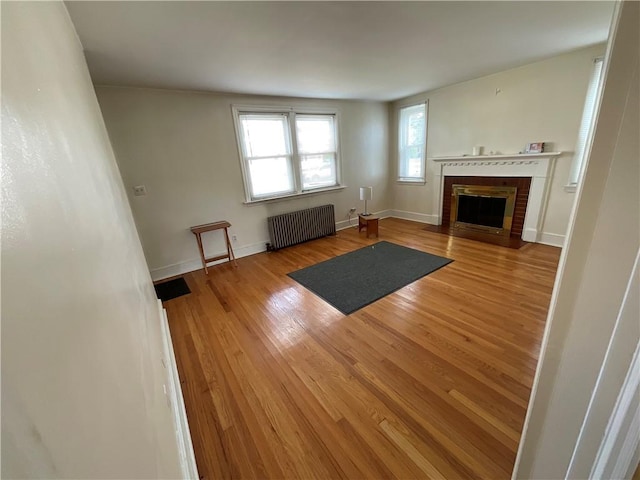 94 Alvin St, Warwick, RI 02886 - unfurnished living room with radiator heating unit, wood finished floors, and a fireplace