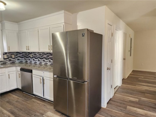 93 Dixon St Unit 1Front, Providence, RI 02907 - kitchen with stainless steel appliances, dark wood finished floors, white cabinets, and tasteful backsplash