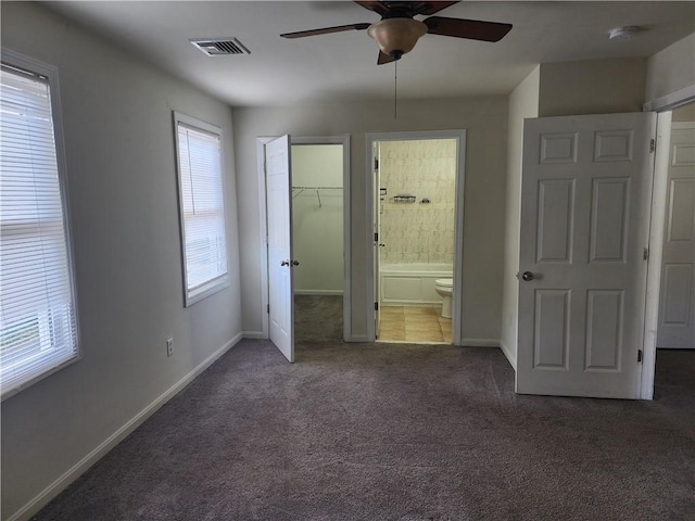 93 Dixon St Unit 1Front, Providence, RI 02907 - unfurnished bedroom with carpet flooring, a spacious closet, a closet, connected bathroom, and a ceiling fan