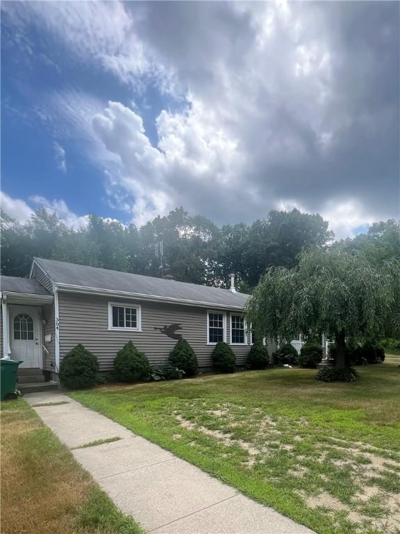 354 Rhodes Ave, Woonsocket, RI 02895 - view of front facade featuring a front yard