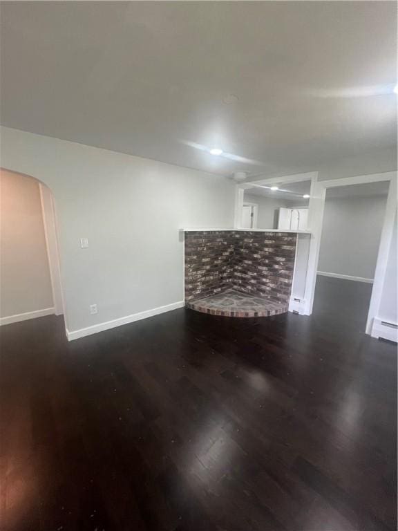 354 Rhodes Ave, Woonsocket, RI 02895 - living room featuring dark wood-type flooring, baseboard heating, and arched walkways