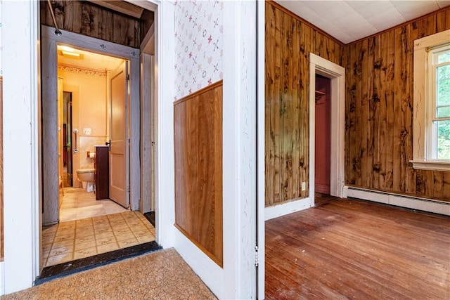 3442 Flat River Rd, Coventry, RI 02816 - hall featuring a baseboard radiator, wood finished floors, and wood walls