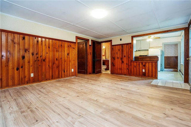 3442 Flat River Rd, Coventry, RI 02816 - unfurnished living room featuring wood finished floors, ceiling fan, wallpapered walls, and wooden walls