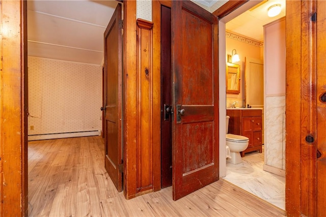 3442 Flat River Rd, Coventry, RI 02816 - corridor with a baseboard radiator, light wood-style flooring, and wallpapered walls